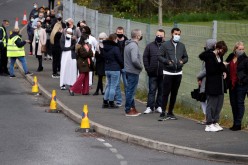 People line up outside a mobile vaccination centre, amid the outbreak of the coronavirus disease (COVID-19), in Bolton, Britain,