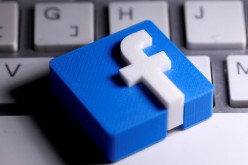 A 3D-printed Facebook logo is seen placed on a keyboard in this illustration 
