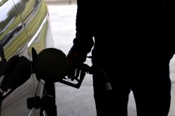 A motorist tops up the fuel in his car's gas tank after a lengthy wait to enter a gasoline station during a surge in the demand for fuel following the cyberattack that crippled the Colonial