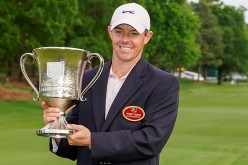 May 9, 2021; Charlotte, North Carolina, USA; Rory McIlroy (L) poses with the winner's trophy at the Wells Fargo Championship golf tournament.
