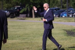 U.S. President Joe Biden waves before boarding the Marine One helicopter for a trip to the Coast Guard Academy from the Ellipse at the White House in Washington,