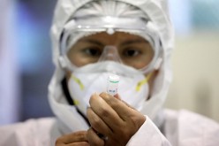 A healthcare worker prepares a dose of China's Sinopharm COVID-19 vaccine in La Paz,