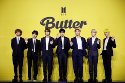 Members of K-pop boy band BTS pose for photographs during a photo opportunity promoting