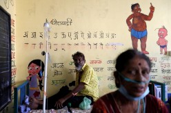 Patients suffering from coronavirus disease (COVID-19) receive oxygen support as they sit inside a classroom turned COVID-19 care facility on the outskirts of Mumbai, India, 