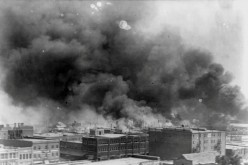 Smoke rises from buildings during the race massacre in Tulsa, Oklahoma, U.S. in 1921. Alvin C. Krupnick Co./National Association for the Advancement of Colored People (NAACP)