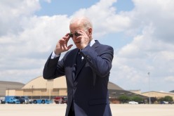 U.S. President Joe Biden takes off his sunglasses to speak to media ahead of his departure from Washington for travel to Cleveland,
