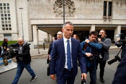 Former Manchester United soccer player Ryan Giggs leaves Manchester Crown Court, where he is charged with assault against two women, 