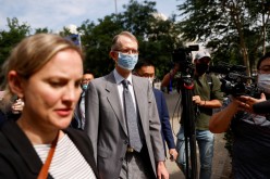 Australia's Ambassador to China, Graham Fletcher, walks outside the Beijing No. 2 Intermediate People's Court where Australian writer Yang Hengjun is expected to face trial on espionage charges, in Beijing,