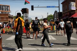 Community members gather after city employees began to reopen George Floyd Square, the area where George Floyd was killed in Minneapolis police custody the year before, in Minneapolis, Minnesota, U.S.,