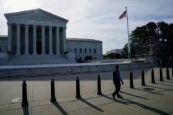 People walk past the U.S. Supreme Court in Washington, U.S.,