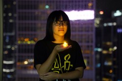 Vice-chairwoman of Hong Kong Alliance in Support of Patriotic Democratic Movements of China, Chow Hang-tung poses with a candle ahead of the 32nd anniversary of the crackdown