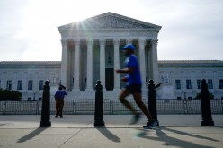 People walk past the U.S. Supreme Court the day the court is set to release orders and opinions in Washington, U.S