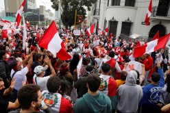 Supporters of Peru's presidential candidate Keiko Fujimori gather on a street near the National Office of Electoral Processes