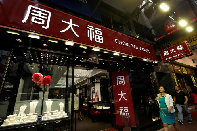 People walk in front of a Chow Tai Fook jewellery store in Hong Kong