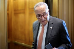 U.S. Senate Majority Leader Chuck Schumer (D-NY) speaks to a reporter about the status of a deal on infrastructure legislation as he departs the Senate floor 