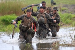 U.S. military forces cross a flooded area near the shore during the annual Philippines-US amphibious landing exercise (PHIBLEX) at San Antonio,
