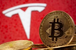 Representations of virtual currency Bitcoin are seen in front of Tesla logo in this illustration taken, 