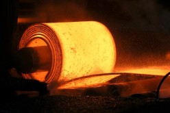 A steel coil is unrolled on the line at the Novolipetsk Steel PAO steel mill in Farrell, Pennsylvania, U.S.