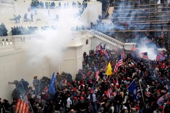 Police release tear gas into a crowd of pro-Trump protesters during clashes at a rally to contest the certification of the 2020 U.S. presidential election results by the U.S. Congress, 