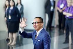 Richard Li, Hong Kong businessman and younger son of tycoon Li Ka-shing, waves as he arrives to vote during the election