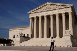 A U.S. Supreme Court police officer patrols the plaza in front the court building in Washington, U.S.