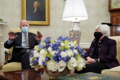 U.S. President Joe Biden speaks next to Treasury Secretary Janet Yellen while receiving the weekly economic briefing in the Oval Office at the White House in Washington