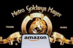 Smartphone with Amazon logo is seen in front of displayed MGM logo in this illustration taken,