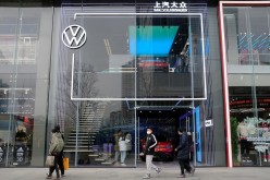 People walk past an ID. Store X showroom of SAIC Volkswagen in Chengdu, Sichuan province, China