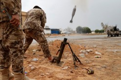 A fighter loyal to Libya's U.N.-backed government (GNA) fires a mortar during clashes with forces loyal to Khalifa Haftar on the outskirts of Tripoli,