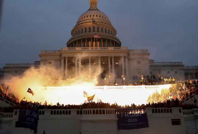  An explosion caused by a police munition is seen while supporters of U.S. President Donald Trump gather in front of the U.S.