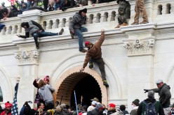  Supporters of U.S. President Donald Trump climb on walls at the U.S. Capitol during a protest against the certification of the 2020 U.S. presidential election results by the U.S. Congress, in Washington, U.S.,