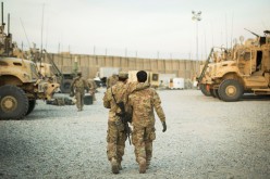 A U.S. soldier from the 3rd Cavalry Regiment walks with the unit's Afghan interpreter before a mission near forward operating base Gamberi in the Laghman province of Afghanistan