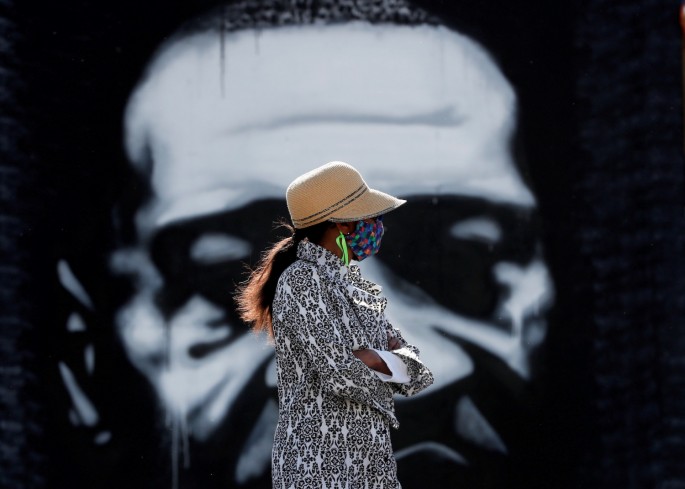 A visitor looks at a memorial at the site of the arrest of George Floyd, who died while in police custody, in Minneapolis, Minnesota, U.S