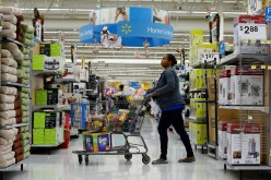  A customer pushes her shopping cart through the aisles at a Walmart store in the Porter Ranch section of Los Angeles