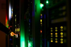 A man poses inside a server room at an IT company