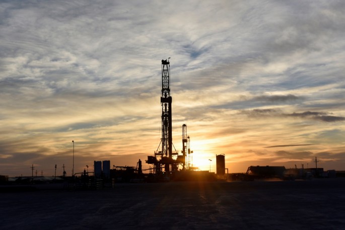 Drilling rigs operate at sunset in Midland, Texas, U.S.