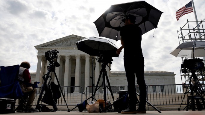Television news photographers prepare to cover the final opinions of the current court’s term at the U.S. Supreme Court building in Washington, U.S.