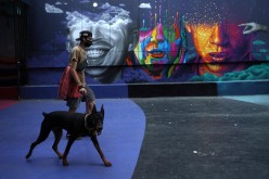  A man walks a dog as lockdown restrictions increase during the coronavirus disease (COVID-19) outbreak, in Santiago, Chile,