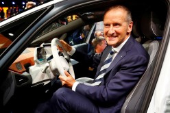 Herbert Diess, CEO of German carmaker Volkswagen AG, poses in an ID.3 pre-production prototype during the presentation of Volkswagen's new electric car on the eve of the International Frankfurt Motor Show IAA in Frankfurt, 