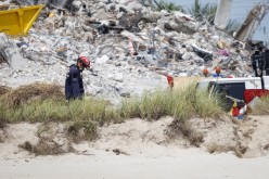 A rescue worker is seen as search-and-rescue efforts resume the day after the managed demolition of the remaining part of Champlain Towers South complex in Surfside, Florida