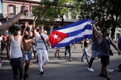 People hold Cuba's national flag during protests against and in support of the government, amidst the coronavirus disease (COVID-19) outbreak, in Havana, Cuba 