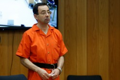 Larry Nassar, a former team USA Gymnastics doctor who pleaded guilty in November 2017 to sexual assault charges, stands in court during his sentencing hearing in the Eaton County Court in Charlotte,