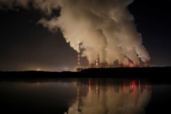 Smoke and steam billows from Belchatow Power Station, Europe's largest coal-fired power plant operated by PGE Group, at night near Belchatow,