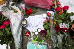 Flowers and a note rest on the place where Dutch celebrity crime reporter Peter R. de Vries has been shot and reported seriously injured in Amsterdam, Netherlands