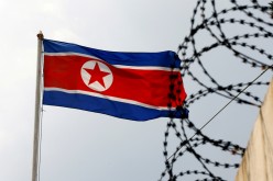 A North Korea flag flutters next to concertina wire at the North Korean embassy in Kuala Lumpur, 