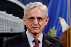 U.S. Attorney General Merrick Garland looks on as he announces that the Justice Department will file a lawsuit challenging a Georgia election law that imposes new limits on voting