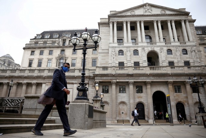 A person walks past the Bank of England in the City of London financial district, in London,