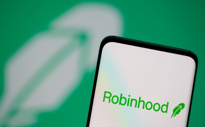 Robinhood logo is seen on a smartphone in front of a displayed same logo in this illustration taken, 