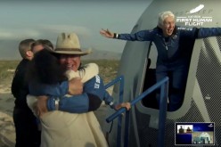 Billionaire businessman Jeff Bezos and pioneering female aviator Wally Funk emerge from their capsule after their flight aboard Blue Origin's New Shepard rocket 
