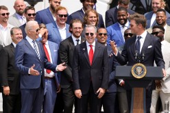 U.S. President Joe Biden reacts next to Buccaneers owner Bryan Glazer and quarterback Tom Brady as the president welcomes members of the NFL Super Bowl champion Tampa Bay Buccaneers